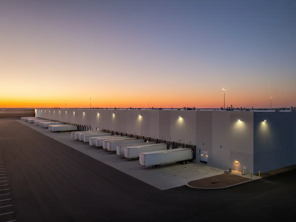 A distribution warehouse and its loading docks at dusk